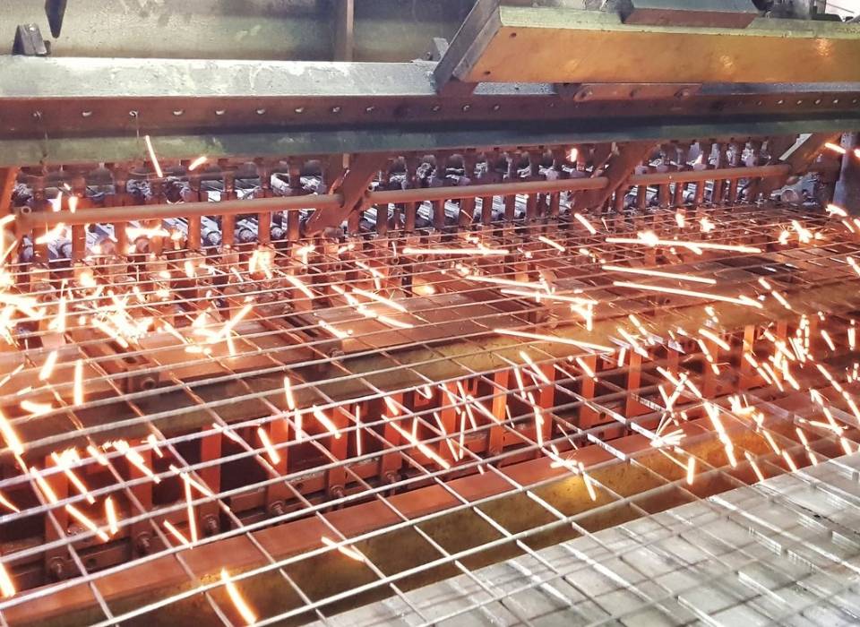 The machine is producing weld-mesh panels for machine guarding system.