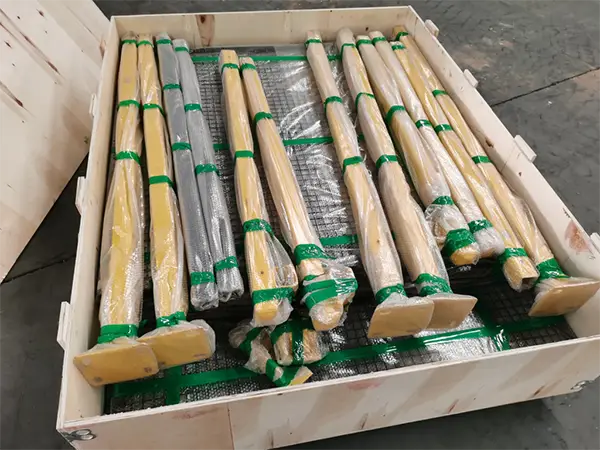 The posts of the machine guarding system are wrapped and secured with green tape.