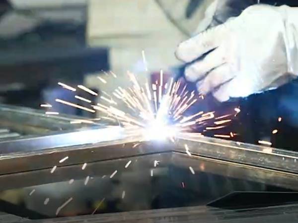 The welder is welding the pipe frame